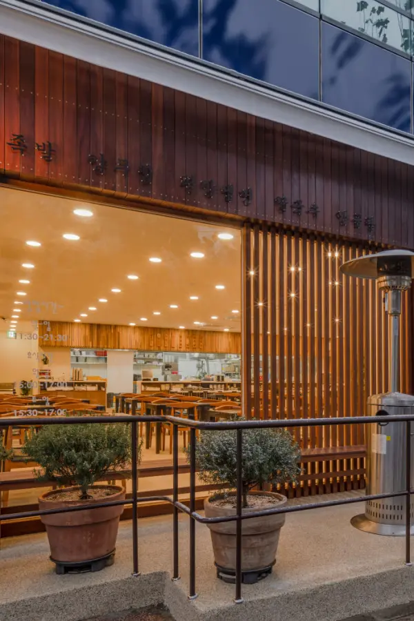 우드 파사드가 돋보이는 모던 한식당 외관